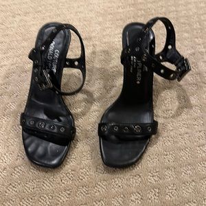 Donald Pliner black leather sandal.  Grommet detail.